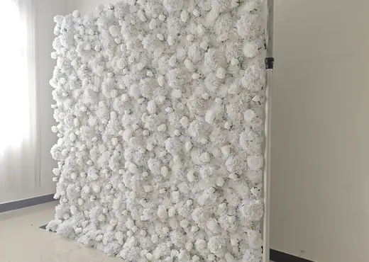 Side angle of white flower wall backdrop for event photo booth setup
