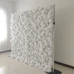Side angle of white flower wall backdrop for event photo booth setup